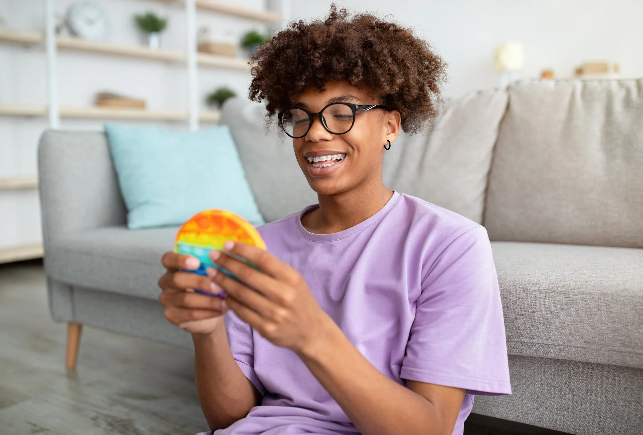 A youth playing a handheld game at one of Georgia Autism Spectrum Disorder (ASD) Crisis Homes.