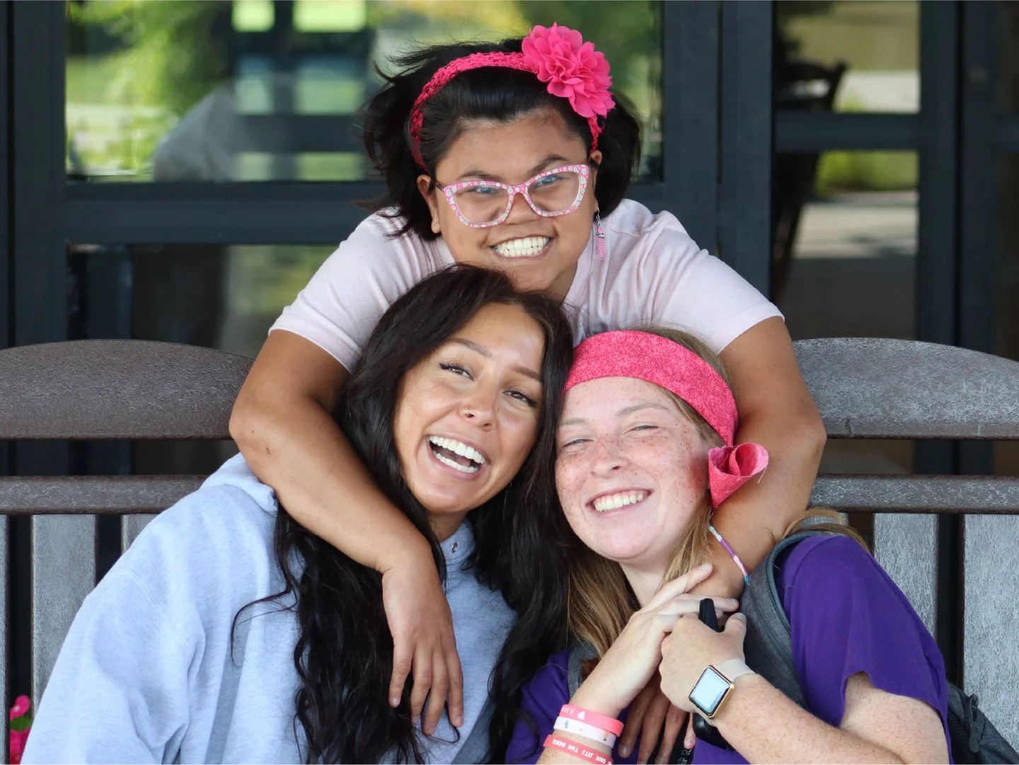 A woman and two young girls at Camp Red Cedar summer camp smiling and having fun.