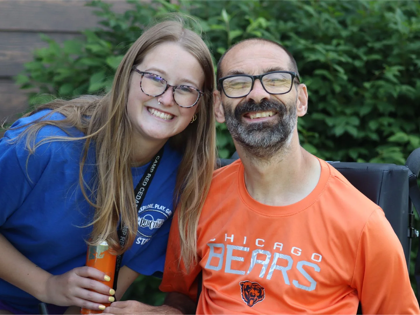 A Camp Red Cedar volunteer and a camp participant smiling.