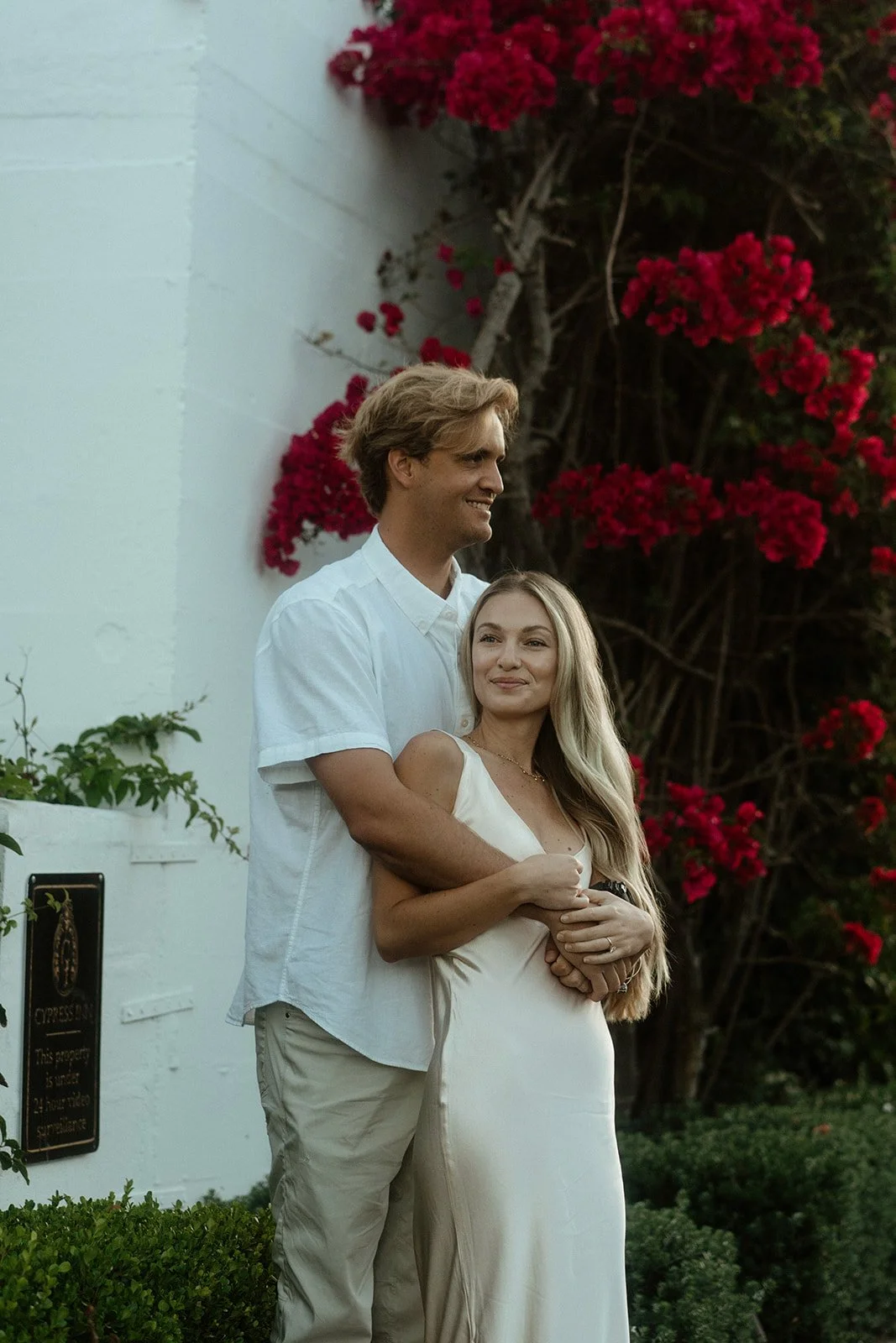  A couple in champagne colored outfits pose for their engagement photos in Carmel by the Sea, California 