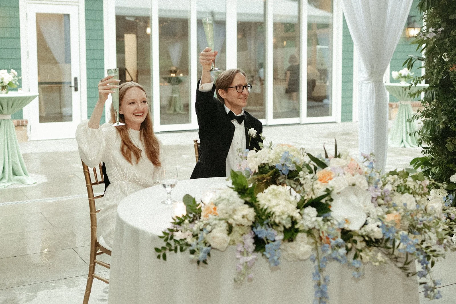  A couple raises their champagne glasses to toast on their wedding day hosted by the VanLandingham Estate in Charlotte, North Carolina 