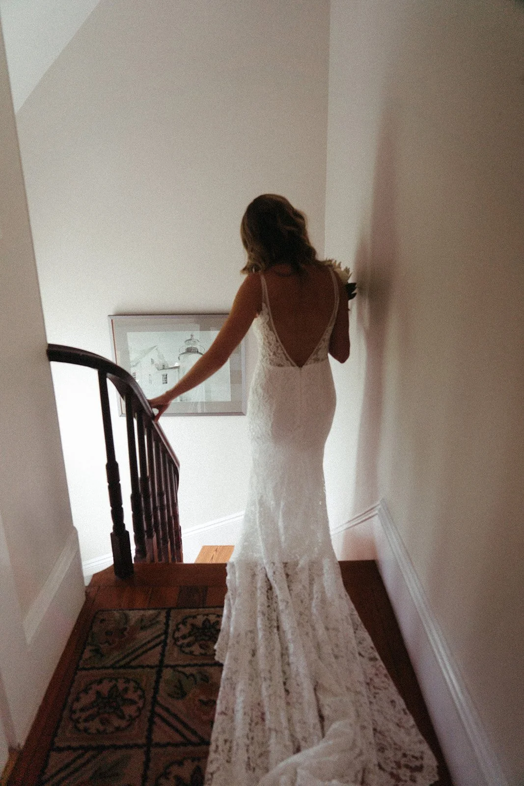 Bride at the top of the steps with a long gown