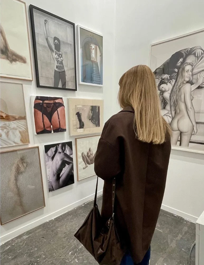 exhibited in Estampa art fair with Alvaro Alcazar Gallery.A fine art black and white photography of a topless woman sitting on a bed, looking over her shoulder