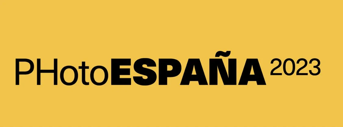 Event logo for PhotoEspana 2023 with a yellow background and black text.