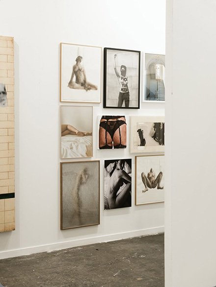 exhibited in Estampa art fair with Alvaro Alcazar Gallery.A fine art black and white photography of a topless woman sitting on a bed, looking over her shoulder