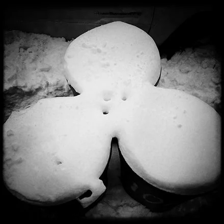Snow shaped like a butterfly on the ground.Each photograph holds infinite meanings — one for every eye that receives it. Titles are withheld so nothing contaminates the private encounter between image and mind. exhibited in New York, Berlin, Madrid. 