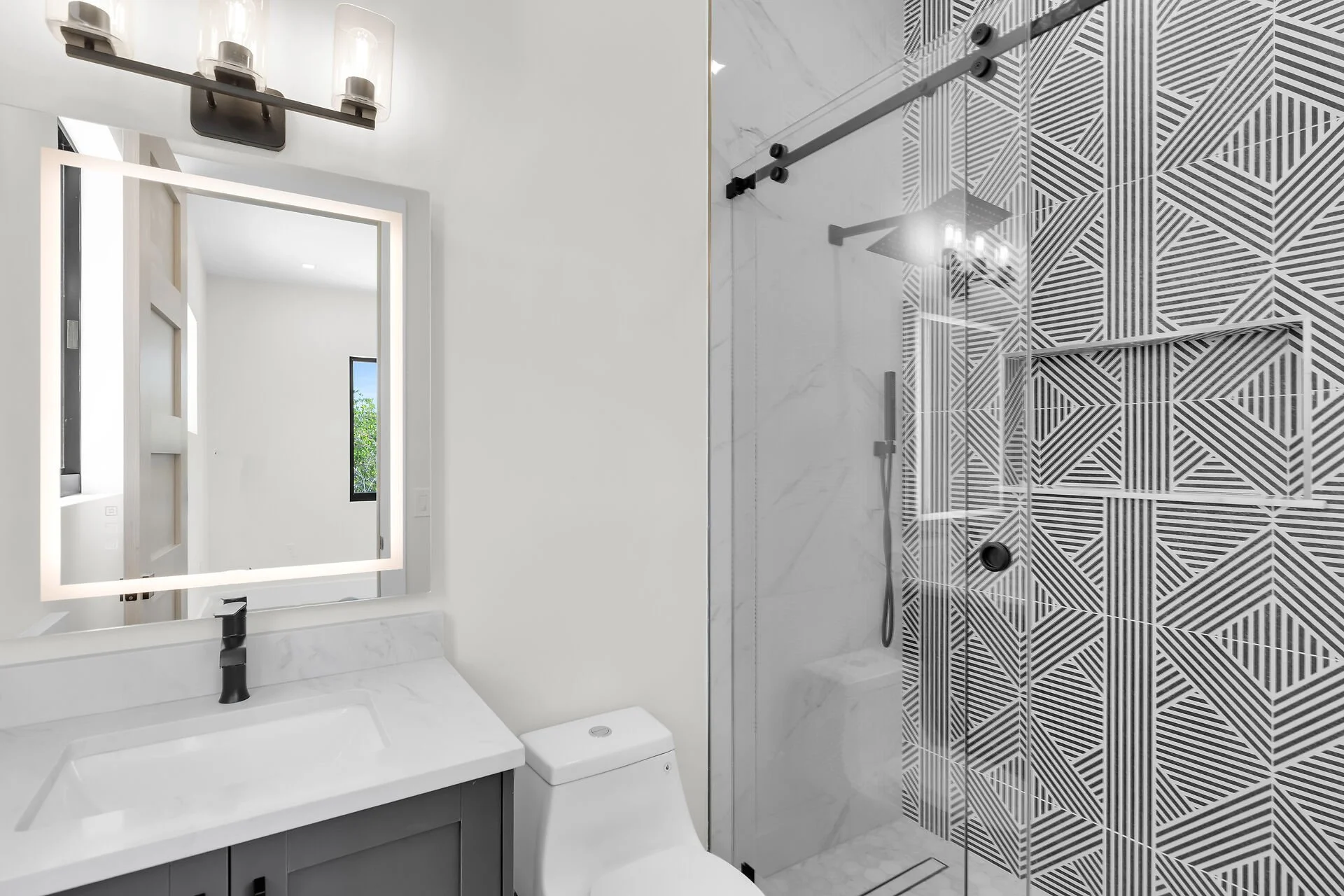 Designer bathroom with frameless glass shower in Stirrup Key luxury home