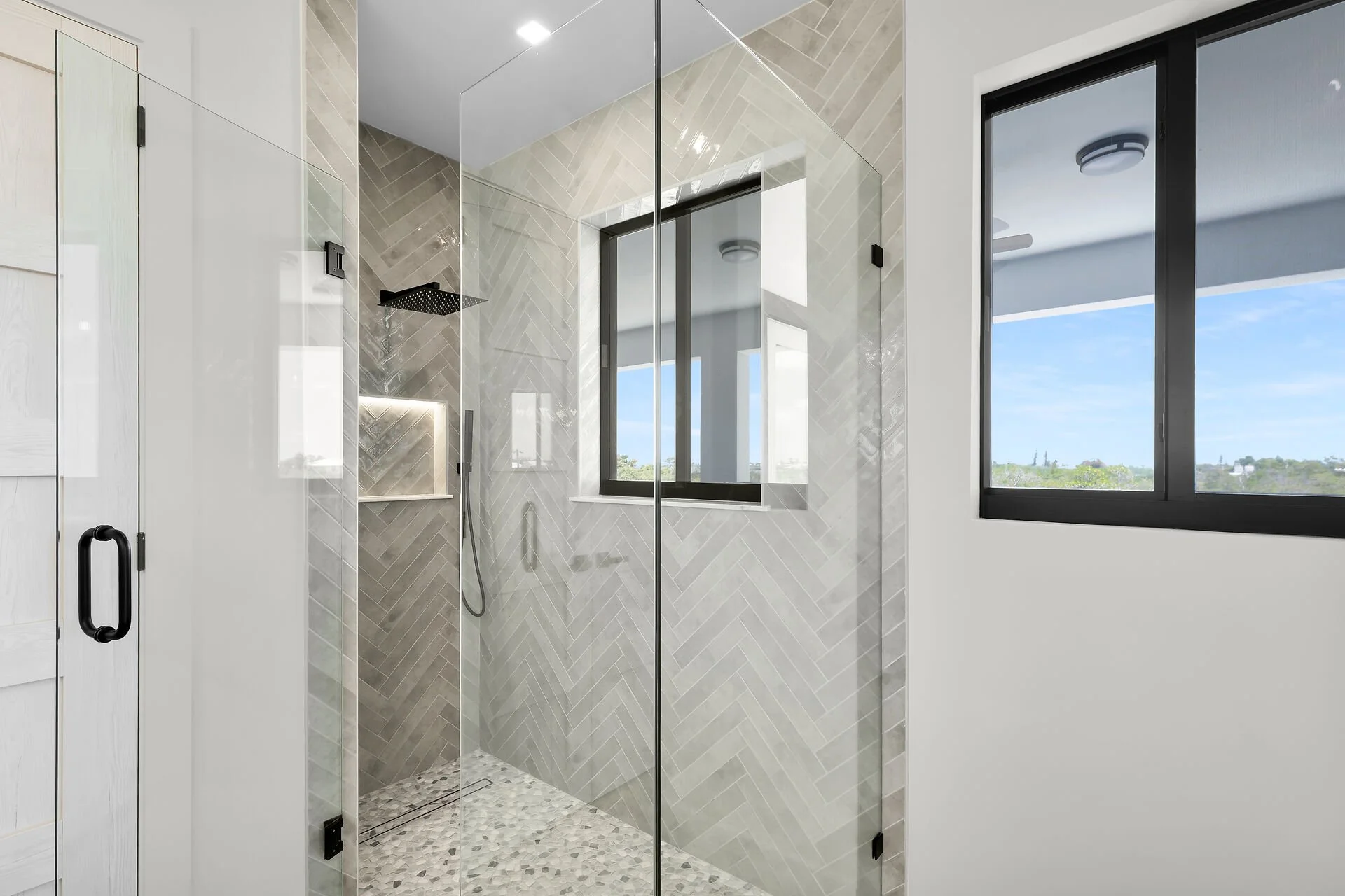 Designer bathroom with frameless glass shower in Stirrup Key luxury home