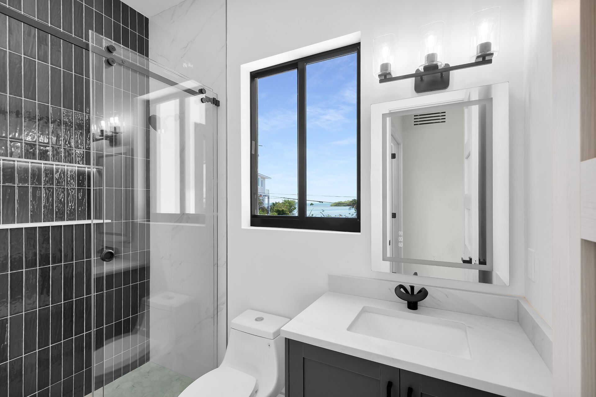 Designer bathroom with frameless glass shower in Stirrup Key luxury home