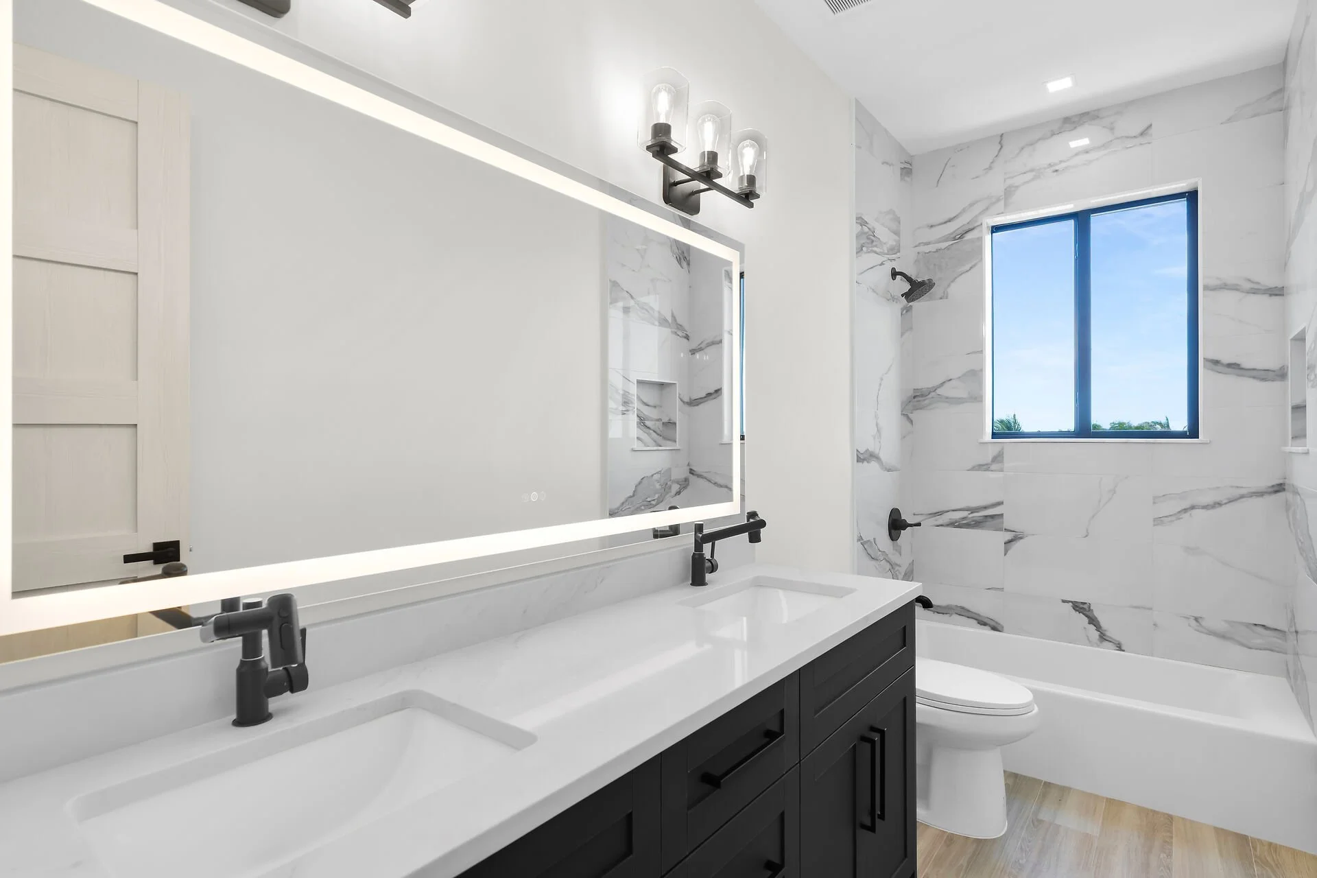Designer bathroom with custom tiled shower in Stirrup Key luxury home