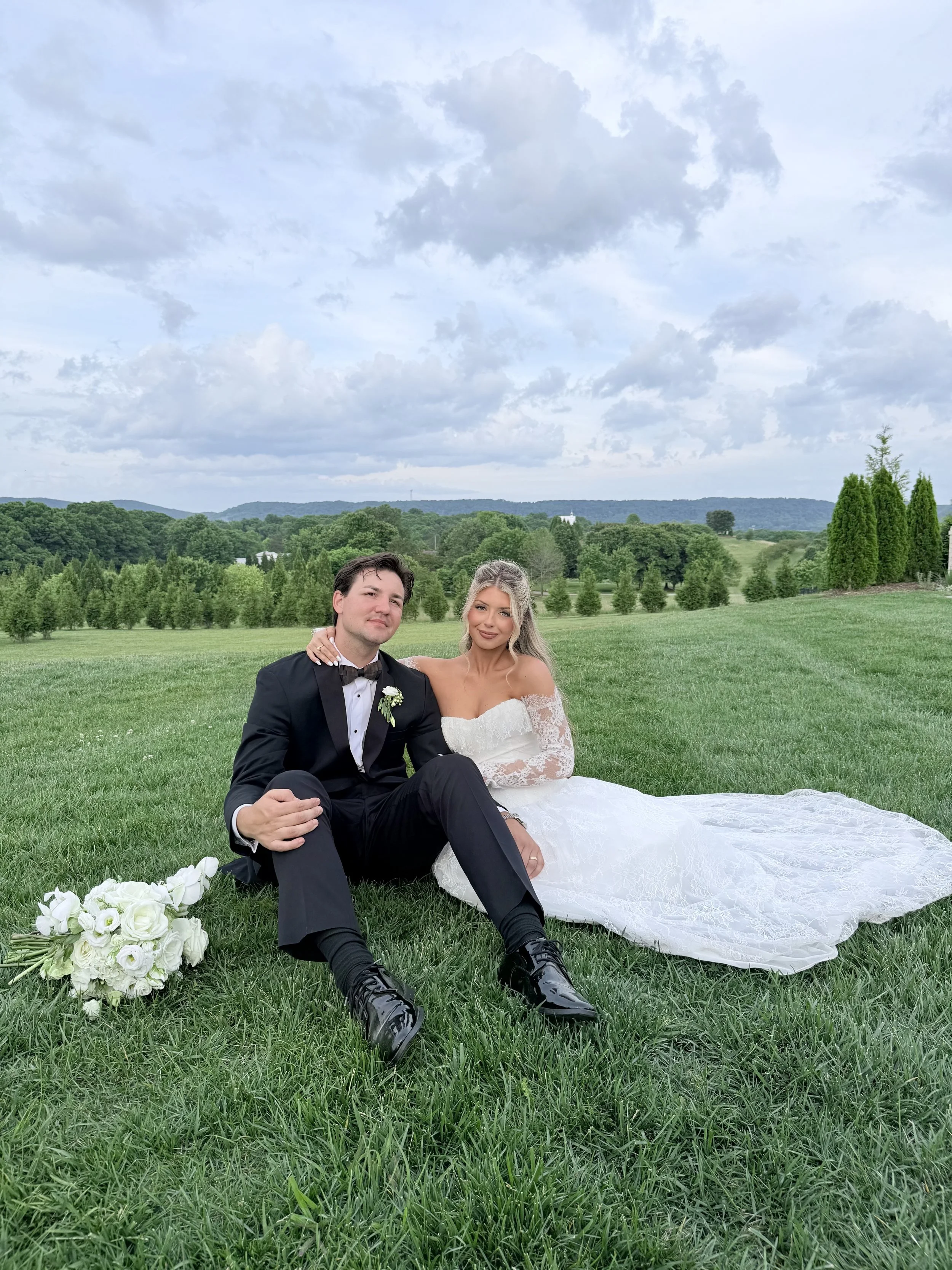 bride and groom posing in grass for wedding content creator