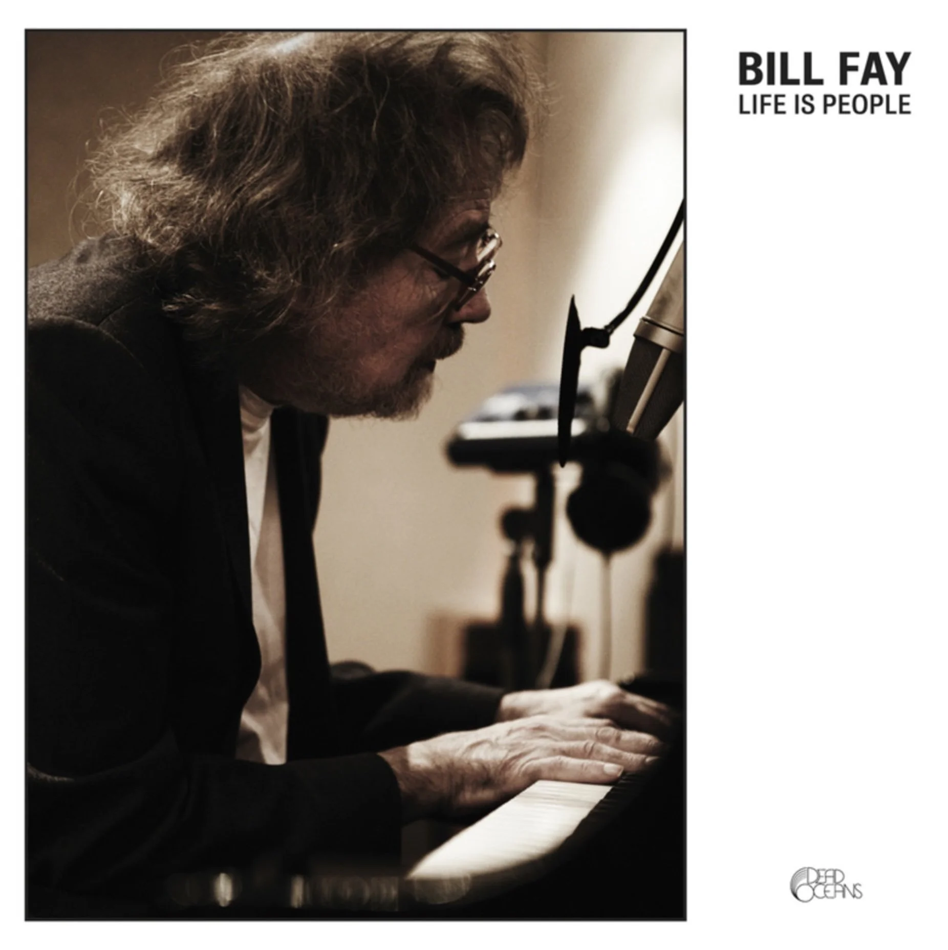 A black-and-white photo of a man with glasses and long hair playing a piano, side profile view, with the text 'Bill Fay Life is People' at the top right corner, and a circle logo with 'Dead Oceans' at the bottom right corner.
