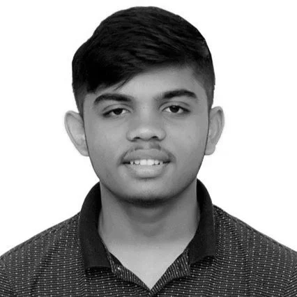 Black and white portrait of a young man with short hair, wearing a collared shirt.