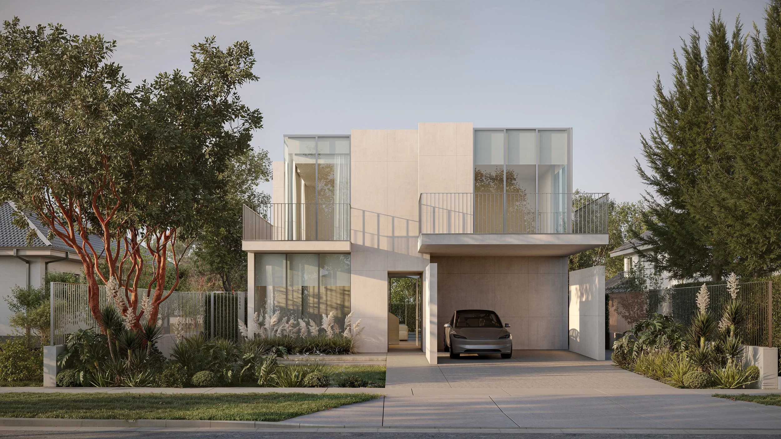 Modern two-story house with large glass windows, driveway with a parked car, surrounded by greenery and trees, under a partly cloudy sky.