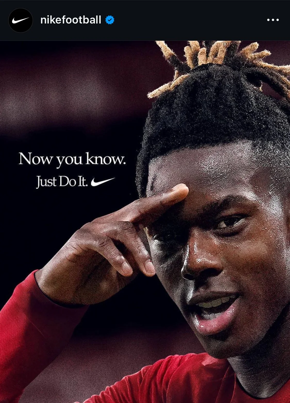 Close-up of Nico Williams, pointing to his temple with his finger, with the text 'Now you know.' and the  Just Do It Nike logo.