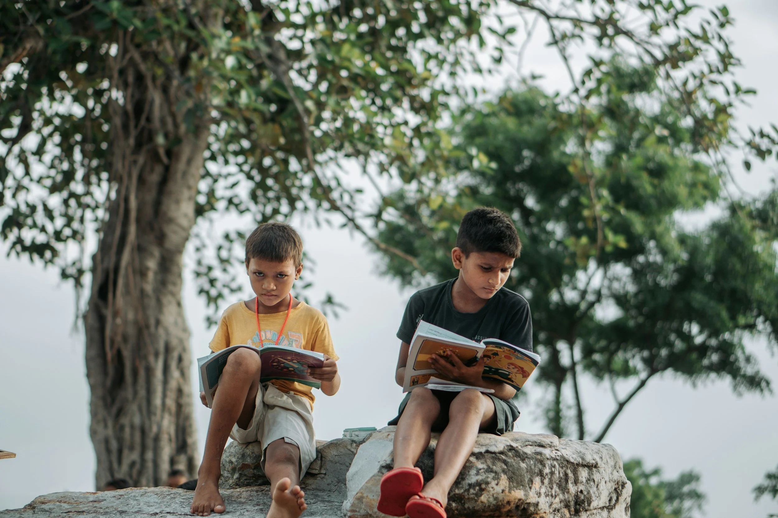 two kids reading in nature