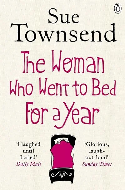 Book cover of "The Woman Who Went to Bed For a Year" by Sue Townsend, featuring a bed with pink bedding and quotes from Daily Mail and Sunday Times.