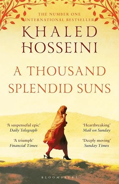 Book cover of 'A Thousand Splendid Suns' by Khaled Hosseini, featuring a woman walking with a headscarf, desert landscape, and red and yellow tones.