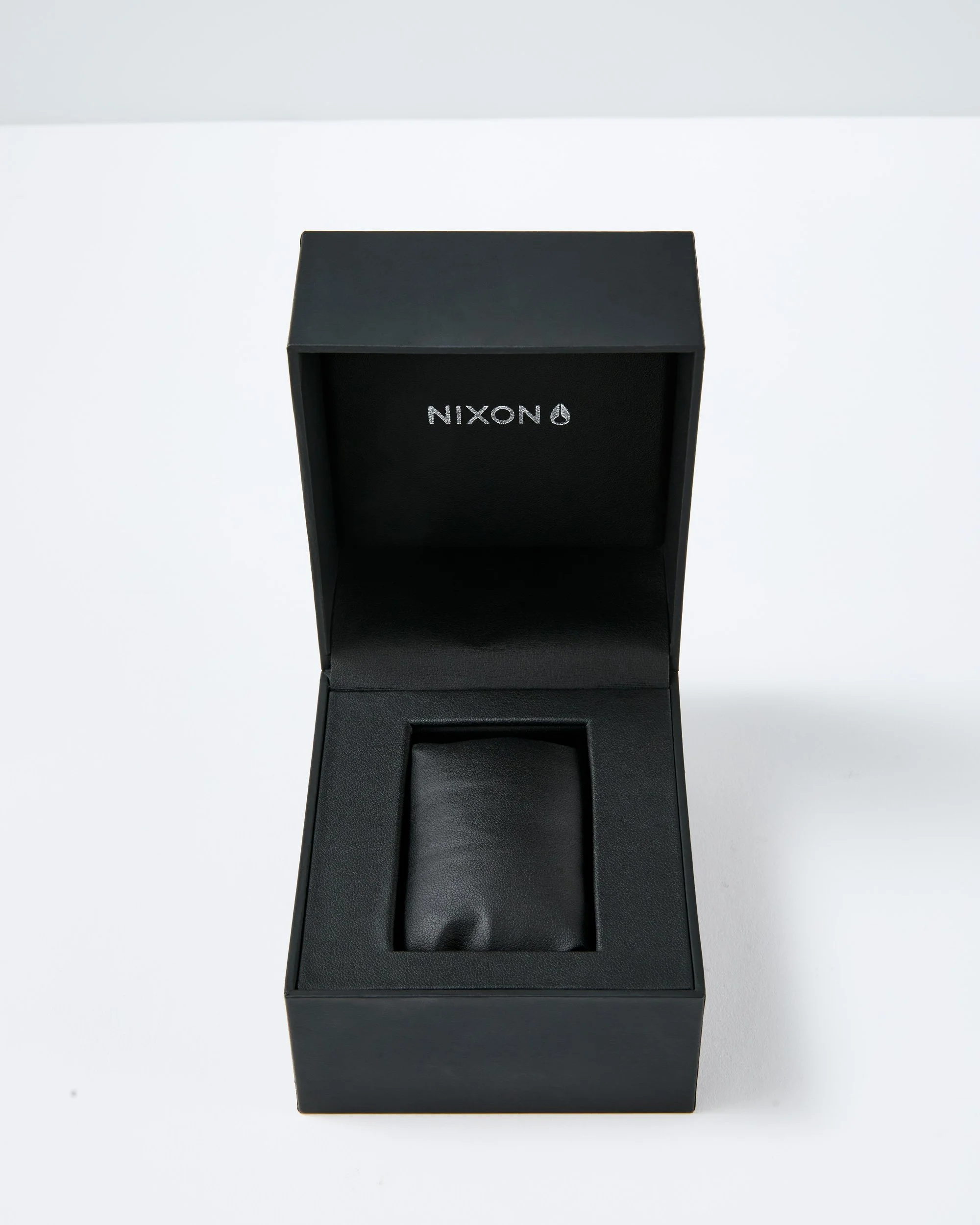 An unretouched shot of a black leather packaging with the brand name 'NIXON' on the front.