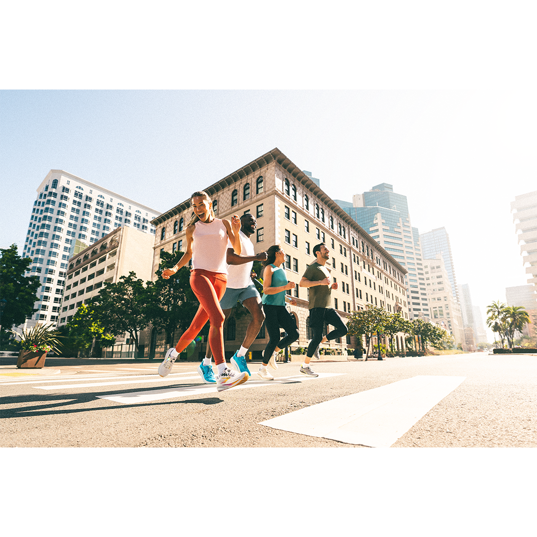 Retouched lifestyle image of a group of five people running on city street in daylight. Edited for Road Runner Sports.