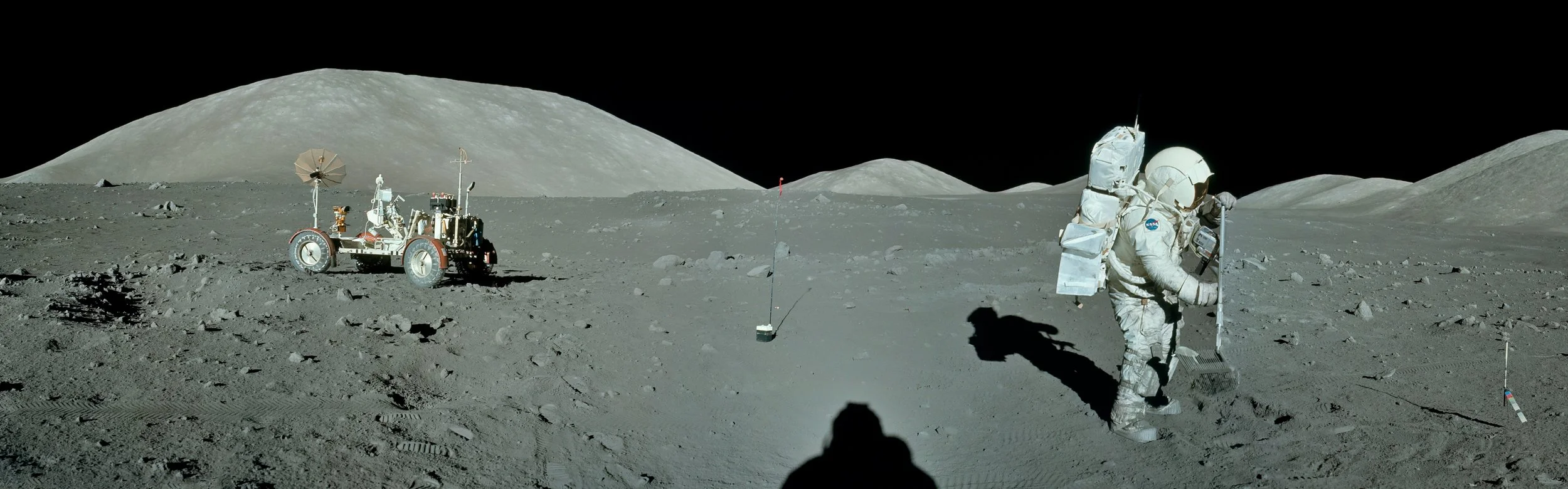 An astronaut in a spacesuit with a backpack and helmet, working on the lunar surface next to a lunar rover, with the Earth’s moon landscape in the background.