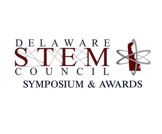 Delaware STEM Council Symposium & Awards logo with text and graphic of a rocket with orbiting rings