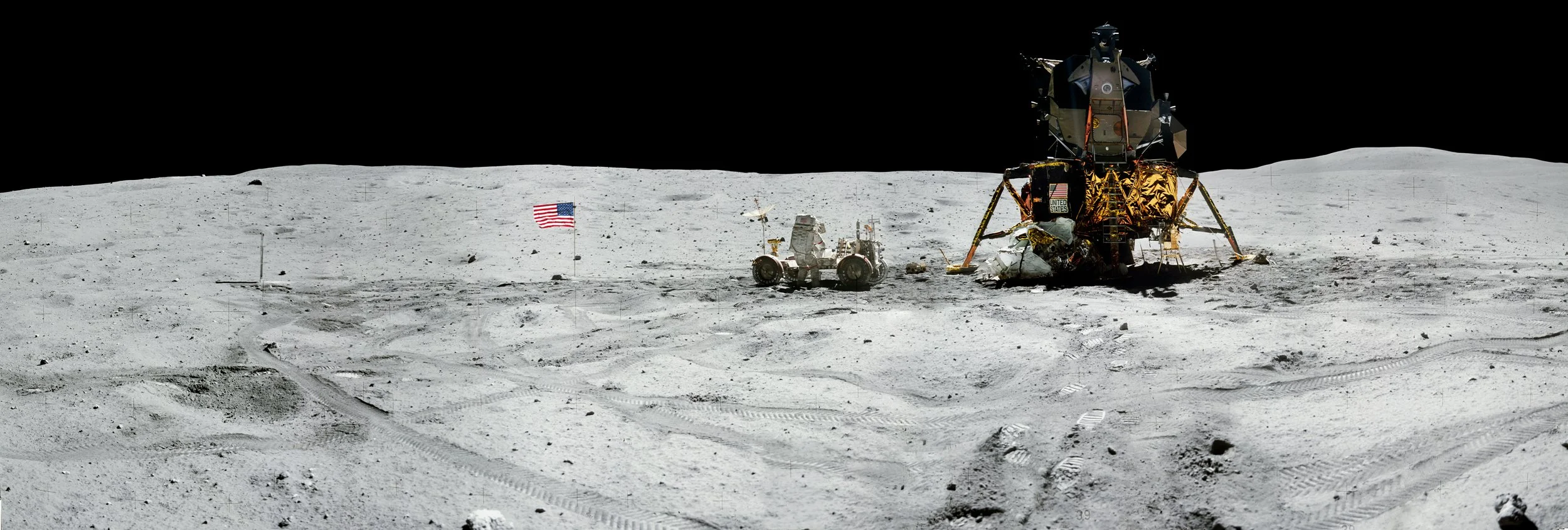 Lunar surface with lunar module, lunar rover, and American flag under black sky.