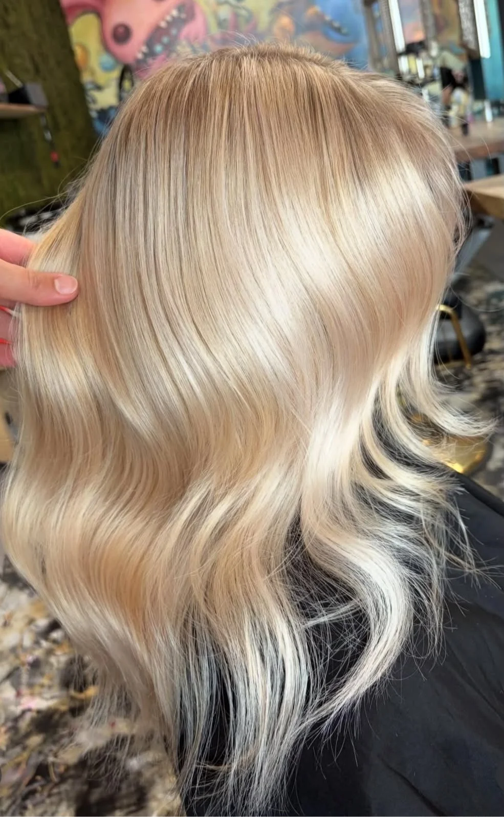 Blond gefärbtes, gewelltes Haarschnitt in einem Friseursalon.