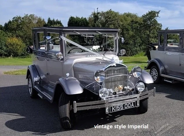A vintage silver and black Imperial style car parked outdoors with a white ribbon across the hood and a white bow on the front grille. The car has a black roof and multiple round headlights, with a license plate reading 'K55 00A' and a caption 'vintage style Imperial' at the bottom of the image.