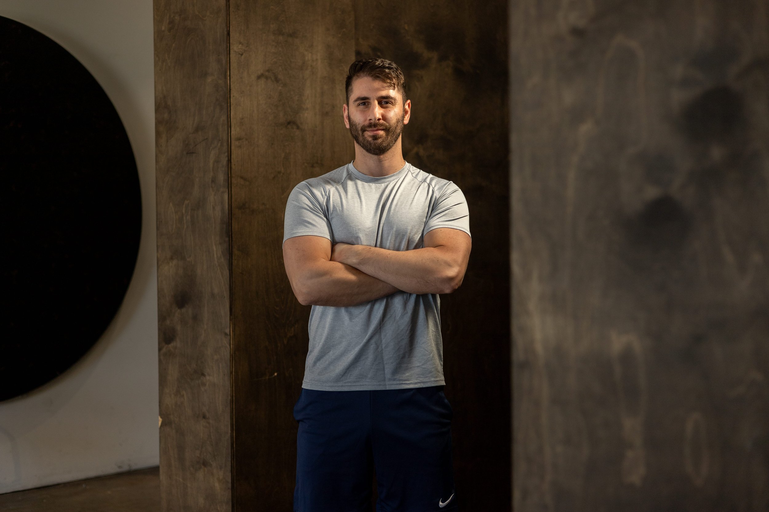 Coach standing confidently with the message: Upgrade your life by mastering your habits, body, and mind — where discipline leads to freedom through intentional daily choices.
