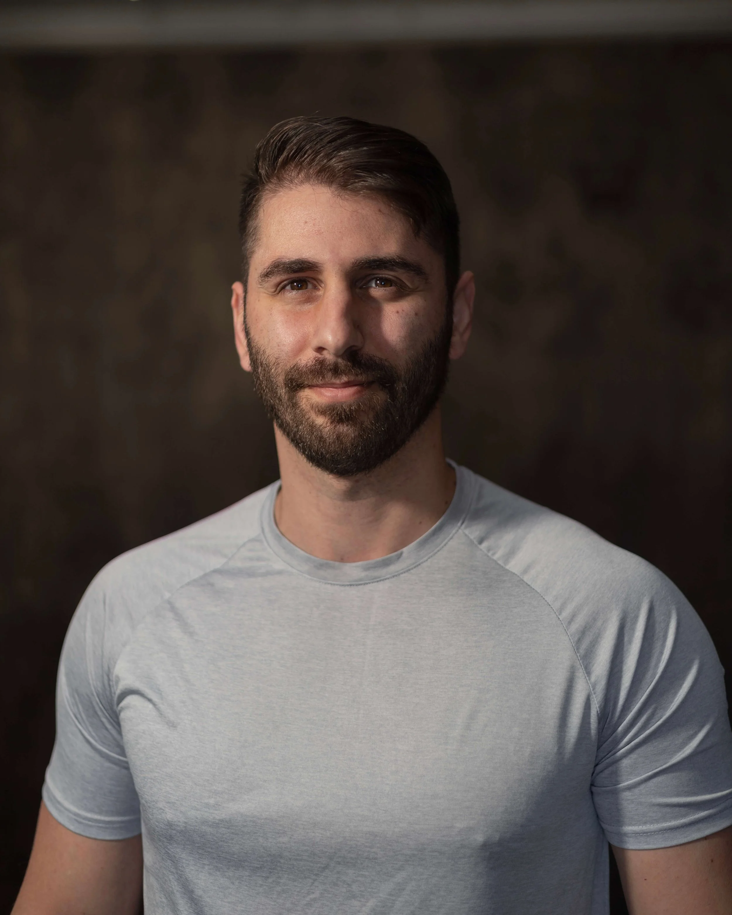 Coach Mike, a Health and Wellness Coach with a background in Kinesiology and Exercise Science, smiling and ready to guide you on your journey to a healthier lifestyle.