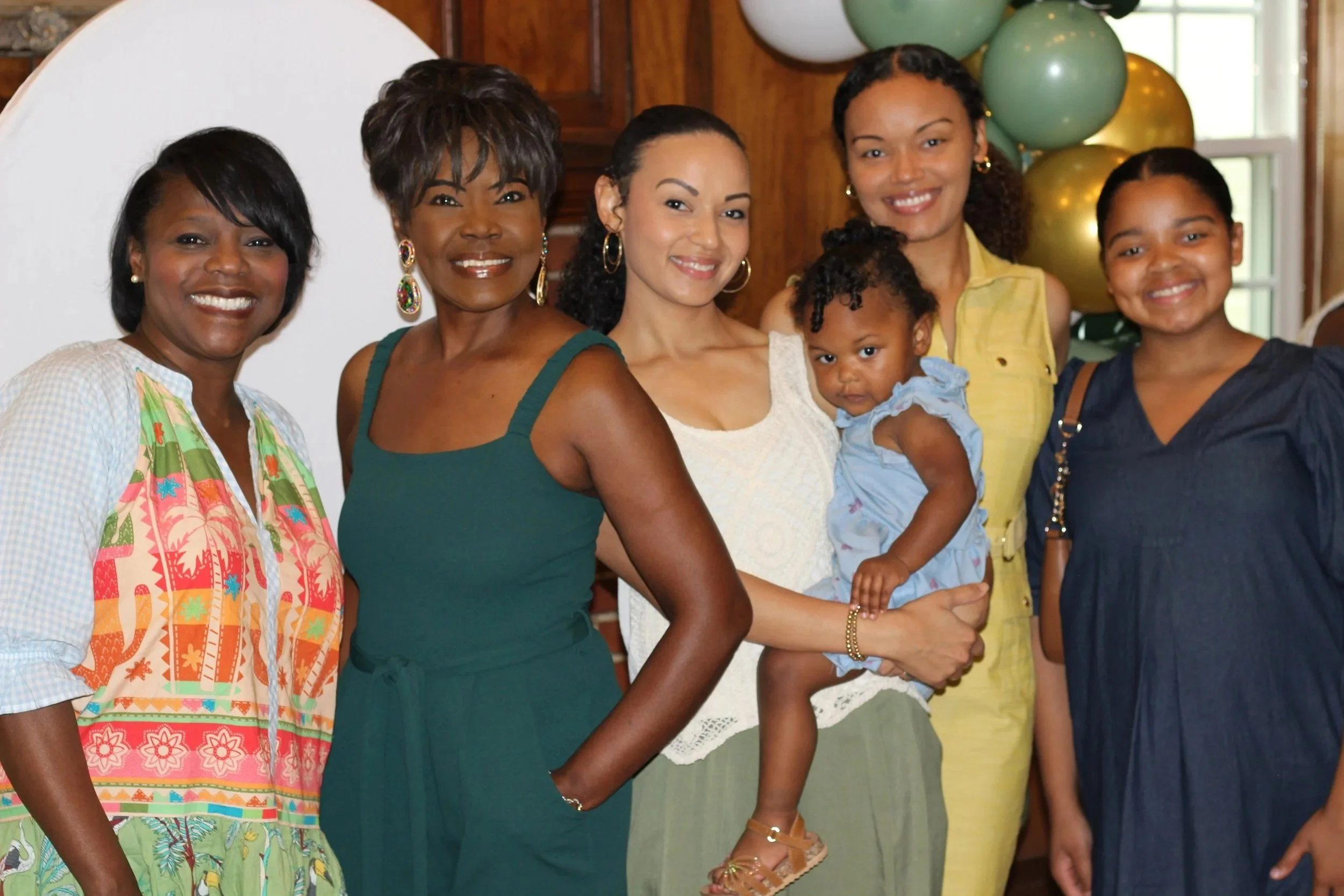 MPR Events LLC team, posing before a custom paradise-themed baby shower.