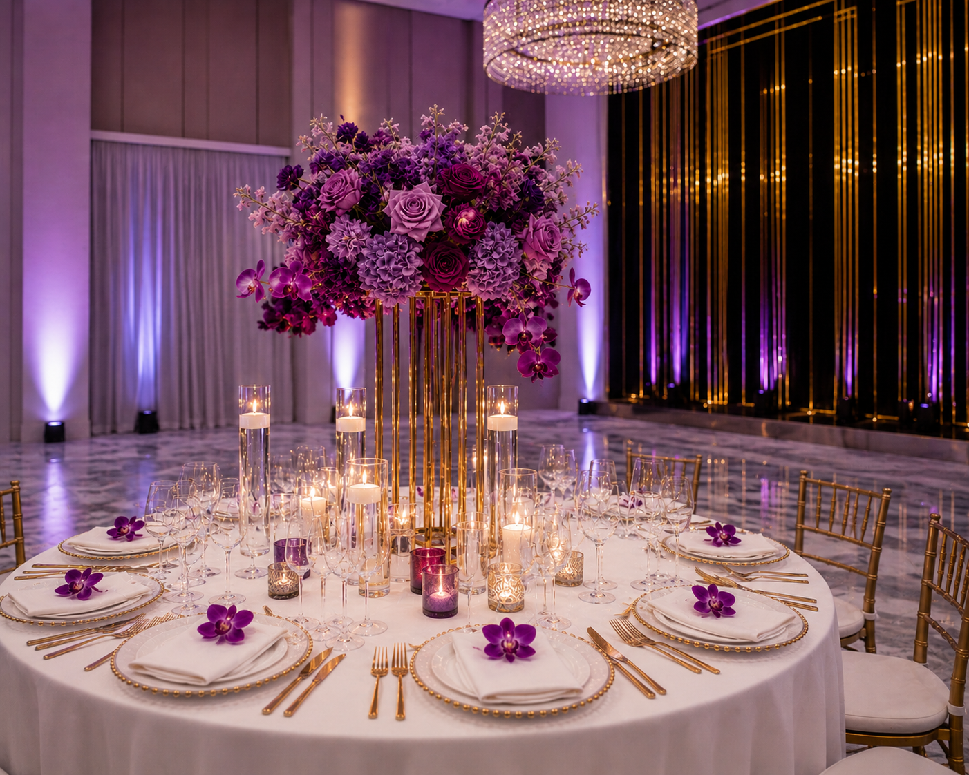 Elegant banquet table with a large purple floral centerpiece, candle holders with lit candles, and purple orchids on each white plate, set for a formal event with gold chairs and purple ambient lighting.