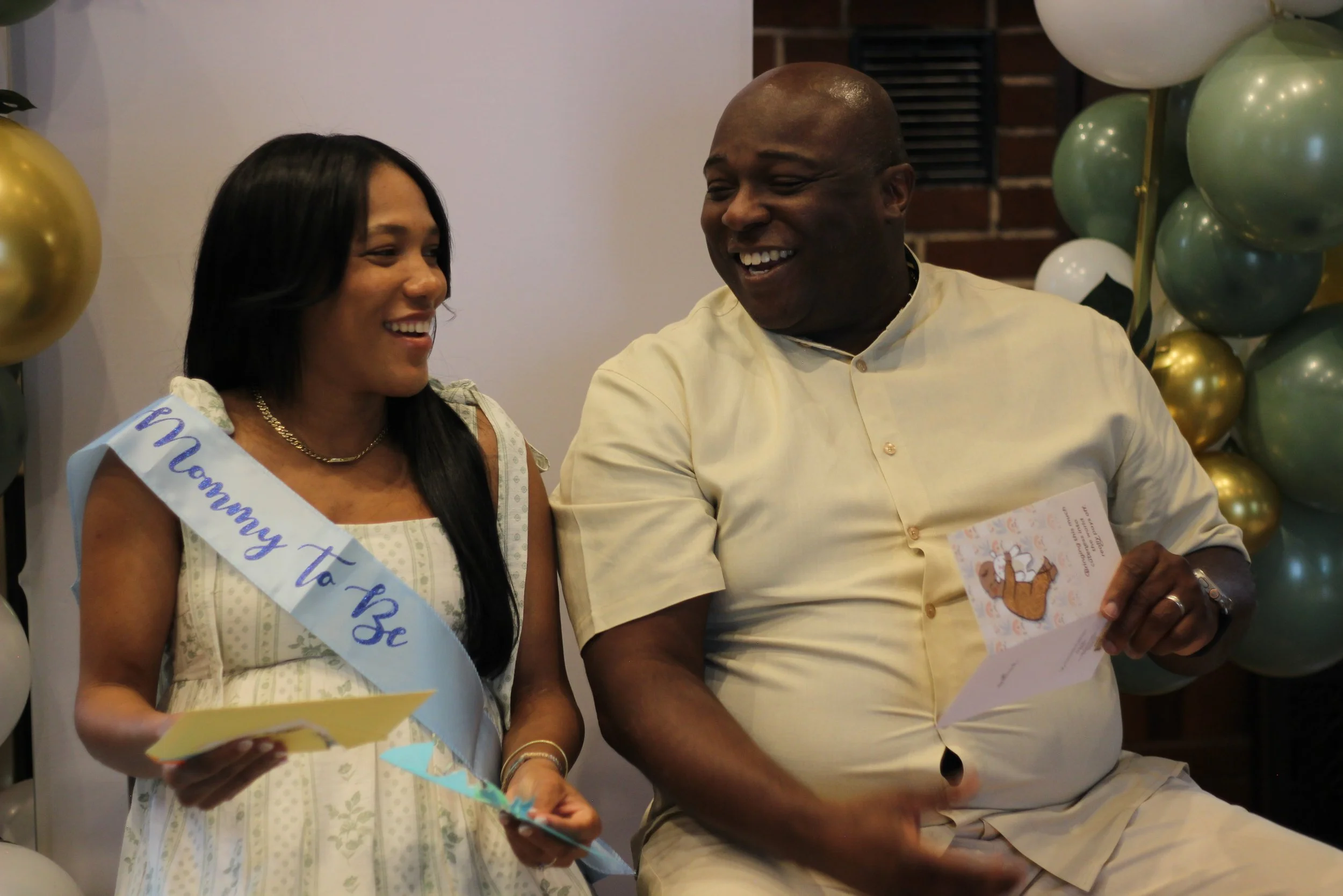 Happy moment shared with Mommy and Daddy to be during a beautiful baby shower, planned, designed, and coordinated by MPR Events LLC.