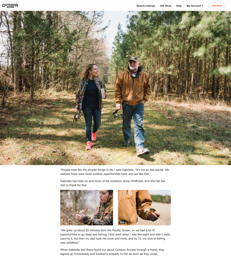 A man and a woman walking in a forested trail, carrying fishing gear, and smiling at each other.