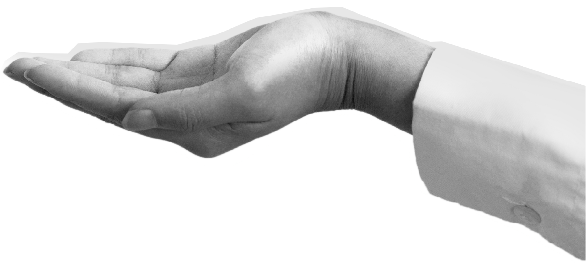 A black and white photo of a person's hand held out with the palm facing up, wearing a white long-sleeve shirt.