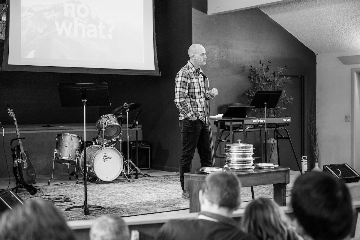 Aaron Hulbert, pastor at Evergreen Church, preaches with communion