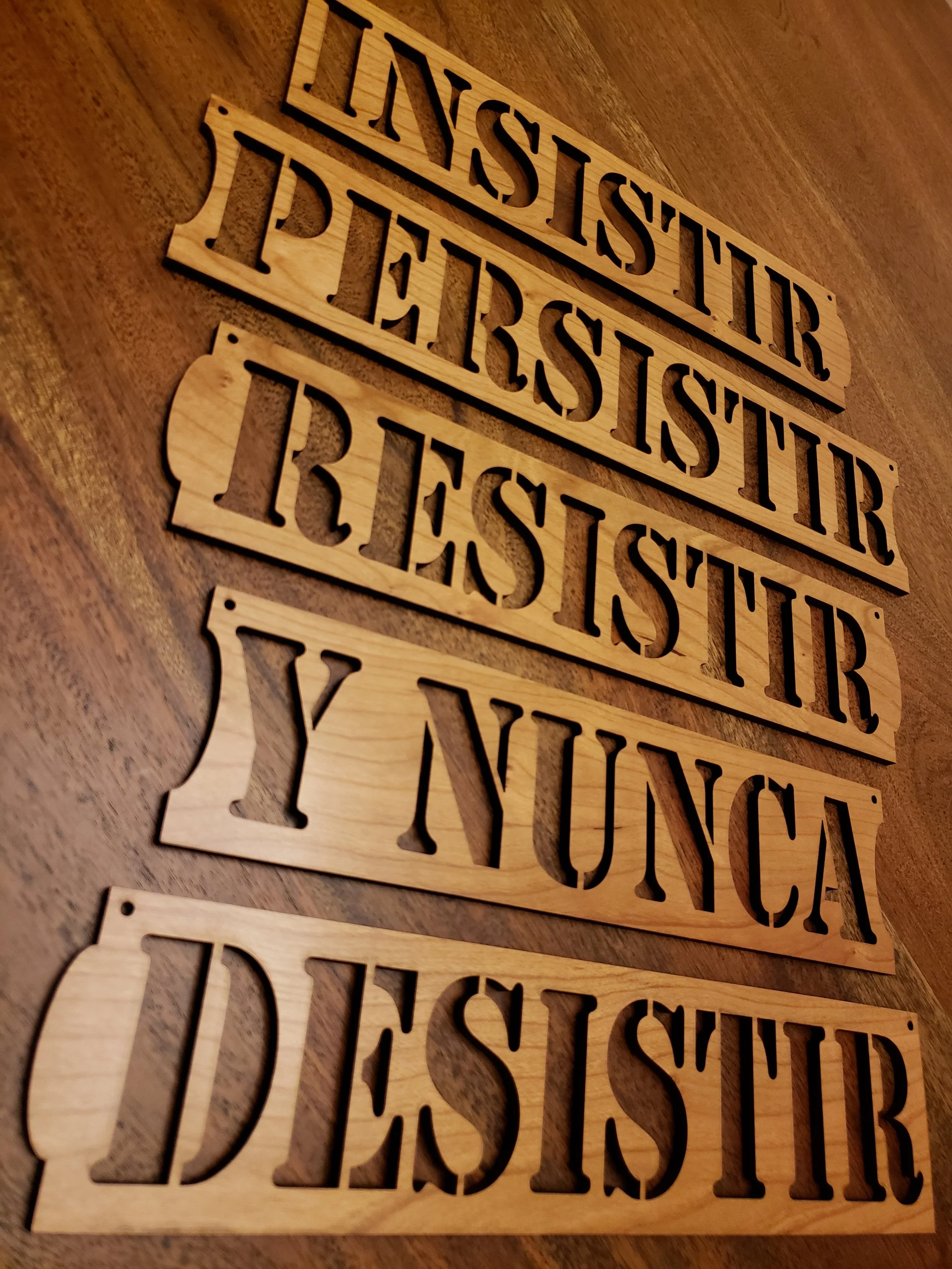Wooden signs with the words 'LIVESTIR PIERSTIR' cut out in bold, uppercase letters, laid on a wooden surface.
