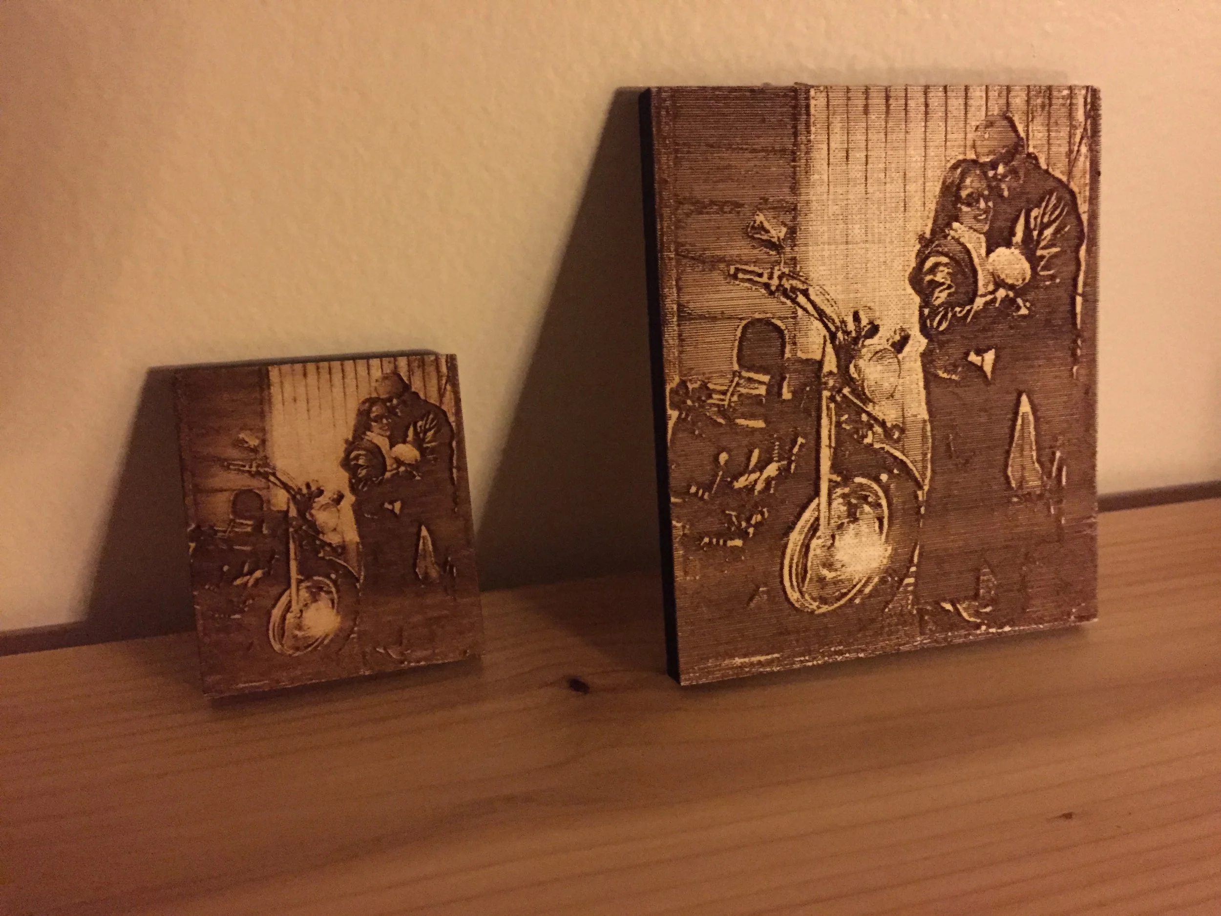 Three wooden blocks with vintage-style illustrations of a smiling man in glasses, working with various objects, placed on a wooden surface against a beige wall.