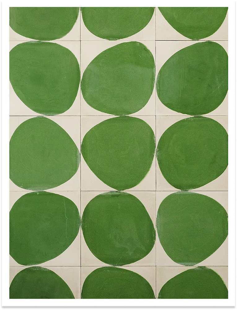 White tiles with large green circular patterns painted on them.