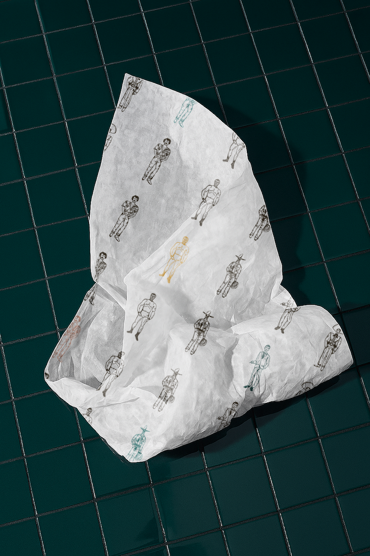 Crinkled tissue paper with various small illustrations of people in different poses laid on a dark green tiled surface.