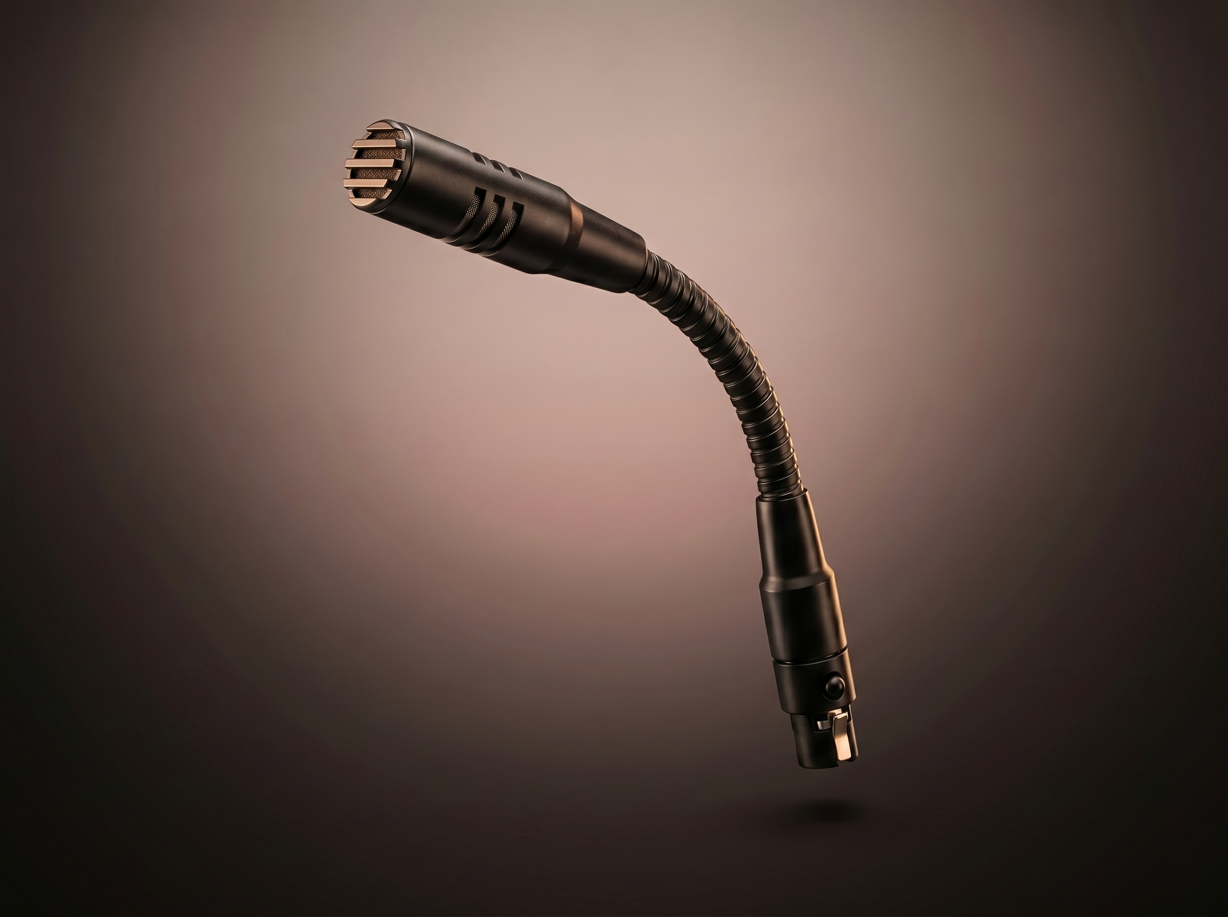 Close-up of a professional recording microphone on a stand against a plain background.