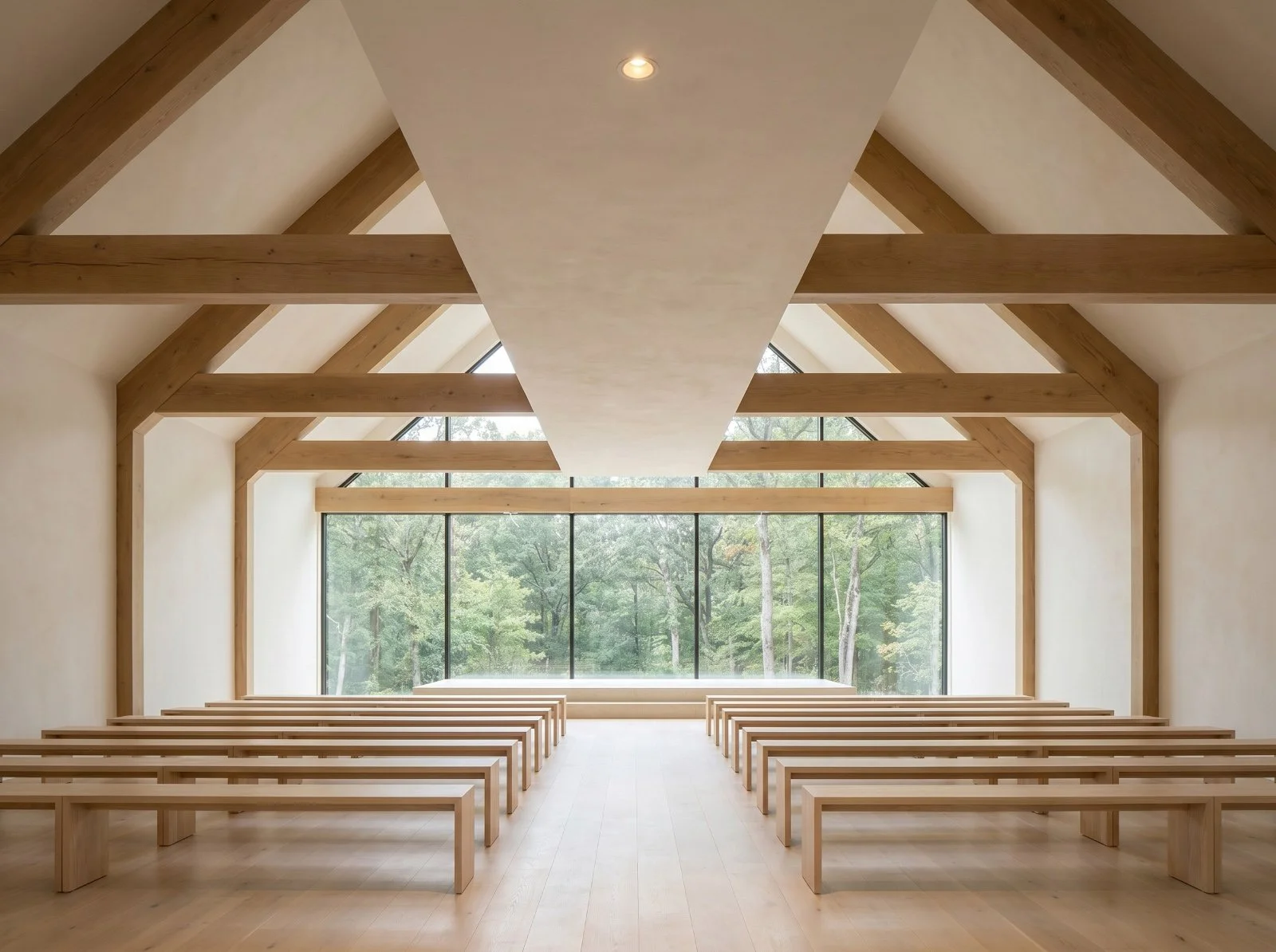 A modern conference room with a long black table, orange chairs, and wooden floors and ceiling. Large windows show a forest view outdoors, and there are hanging pendant lights illuminating the room.