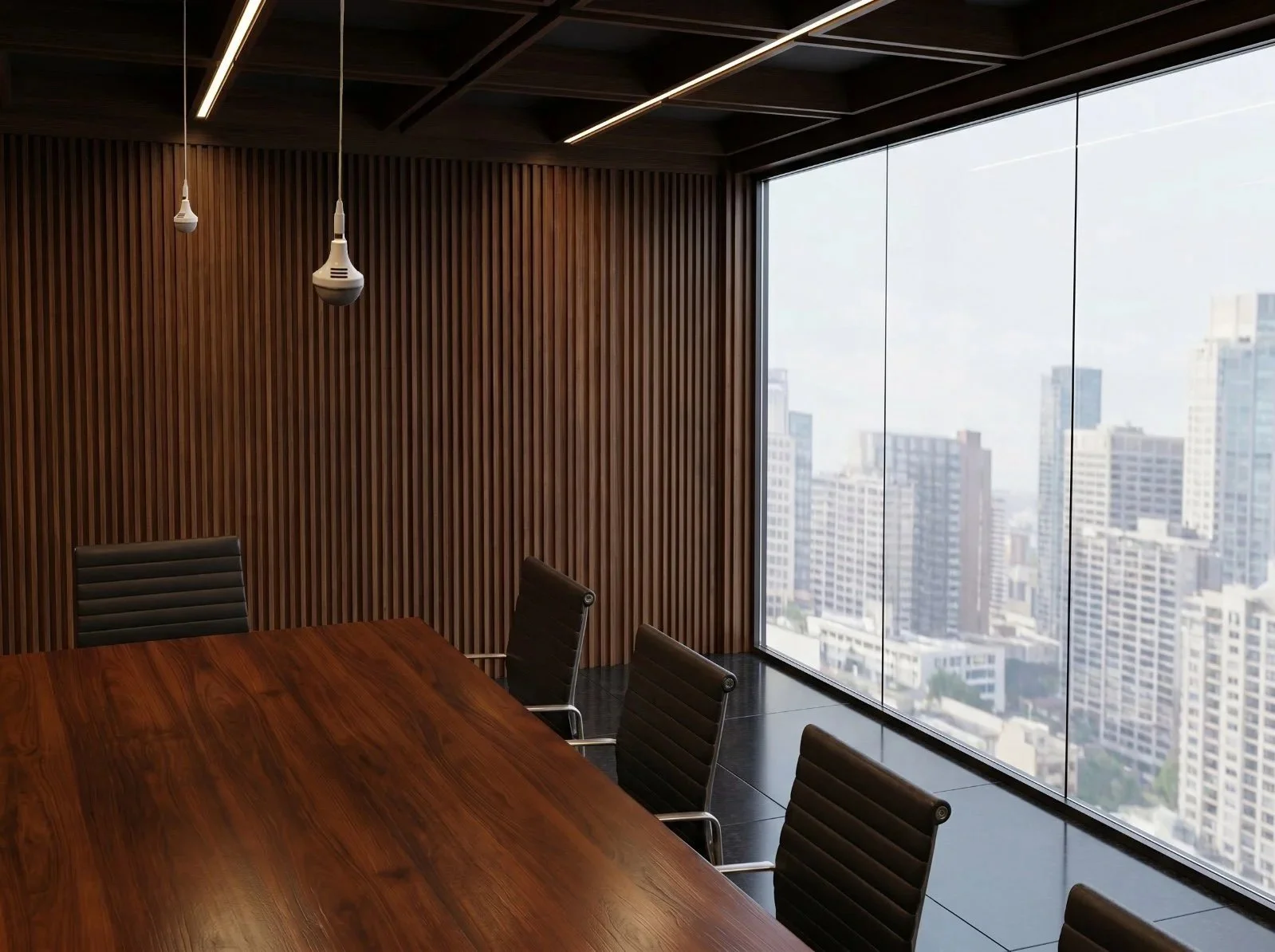 A modern conference room with a long wooden table surrounded by black office chairs. The ceiling features large circular LED light fixtures and a black microphone hanging from the center. There is a large flat screen display on the wall showing a network of interconnected nodes and lines. The room has large windows with white curtains allowing natural light to enter.