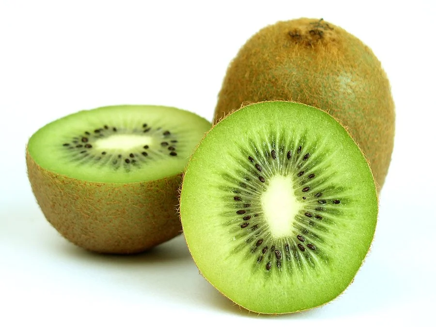 Fresh kiwi fruit sliced open showing green flesh and seeds