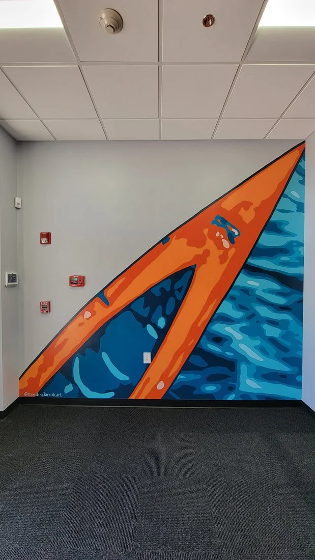 Colorful mural of a surfboard on a wall with water waves design, in an indoor setting.