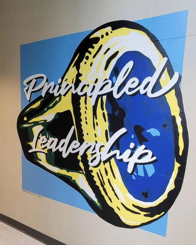 Colorful mural with a lemon slice in the background and the words "Principled Leadership" written across it.