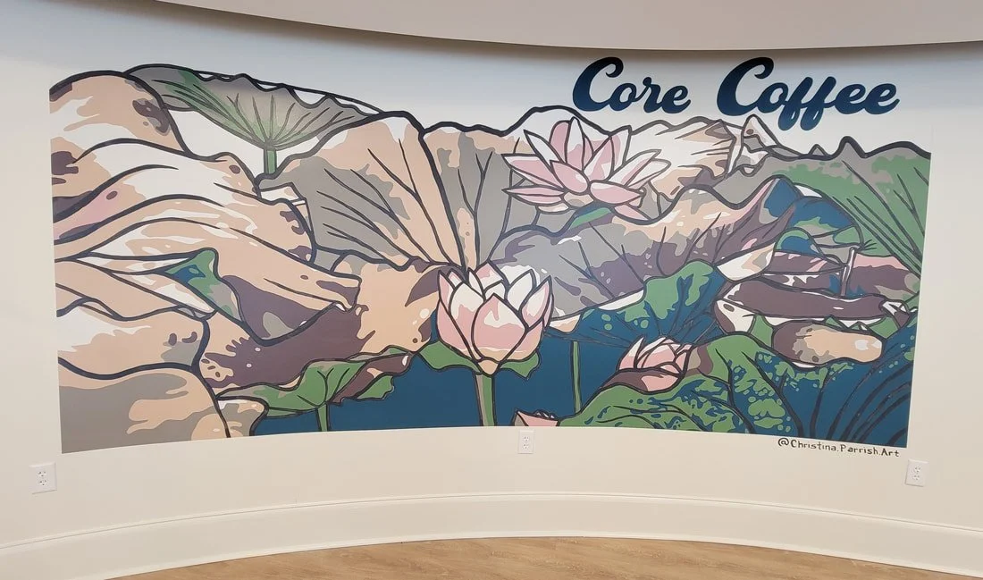 Wall mural with pink lotus flowers, green lily pads, and mountains in the background, featuring the text "Core Coffee".
