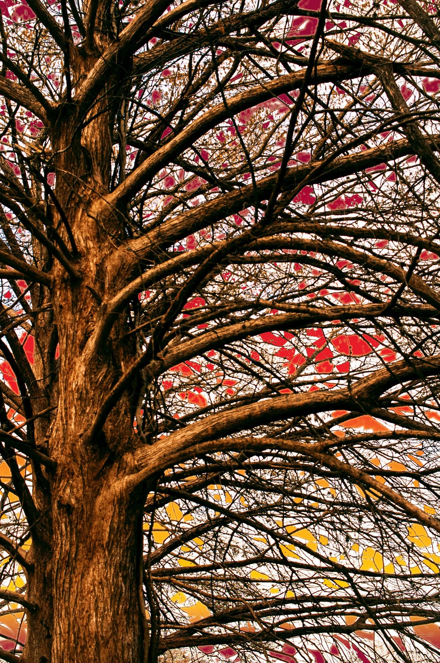 Tree with colorful stained glass leaves and intricate branches against the sky.