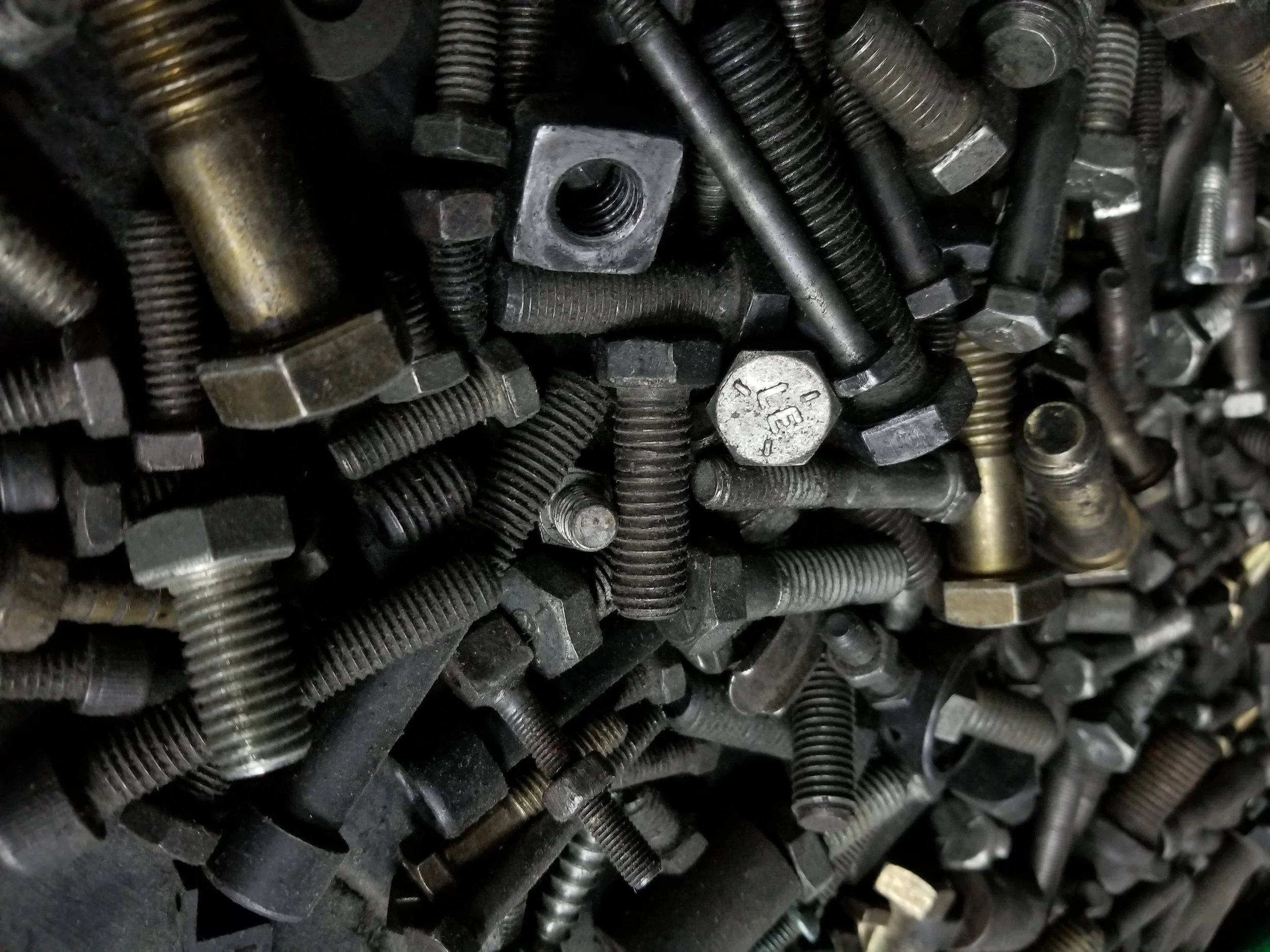 Close-up of assorted metal bolts, nuts, and screws in various sizes